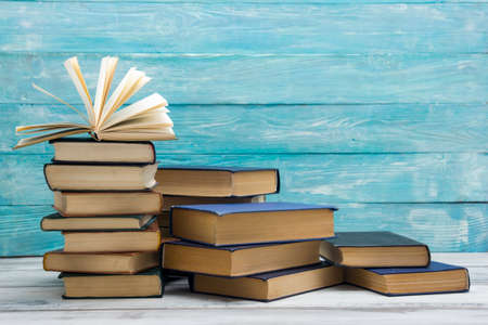 Open book, hardback books on wooden table. Back to school. Copy space.の写真素材