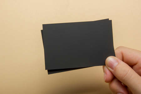 Hand holding white business card on abstract backgroundの写真素材