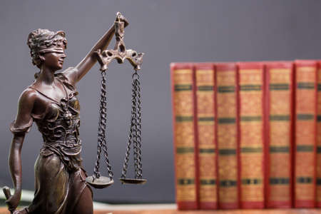 Law concept - Open law book with a wooden judges gavel on table in a courtroom or law enforcement office isolated on white background. Copy space for textの写真素材