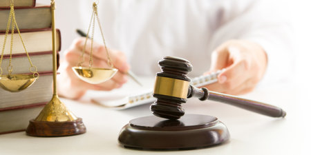 Lawyer working with contract papers and wooden gavel on tabel in courtroom. justice and law,...