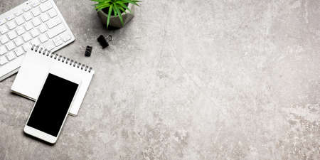 White desk office with laptop, smartphone and other work supplies with cup of coffee. Top view with copy space for input the text. Designer workspace on desk table essential elements on flat lay.の写真素材