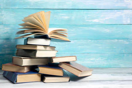 Open book, hardback books on wooden table. Back to school. Copy space.の写真素材