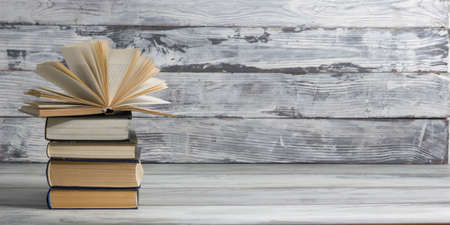 Open book, hardback books on wooden table. Back to school. Copy space.の写真素材