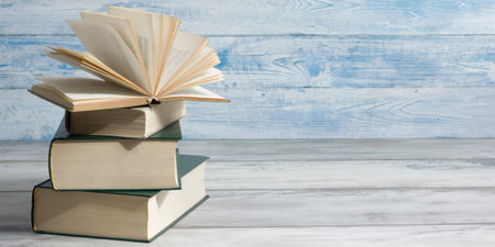Open book, hardback books on wooden table. Back to school. Copy space.の写真素材