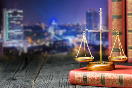 Law concept - Open law book with a wooden judges gavel on table in a courtroom or law enforcement office isolated on white background. Copy space for textの写真素材