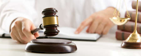 Lawyer working with contract papers and wooden gavel on tabel in courtroom. justice and law, attorney, court judge conceptの写真素材