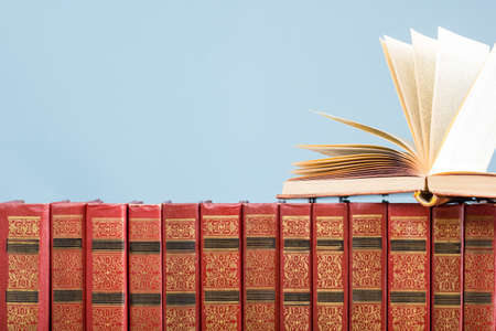 Open book, hardback books on wooden table. Back to school. Copy space.の写真素材