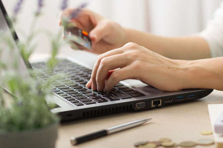 Hands holding credit card and using laptop. Online shopping.の写真素材