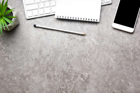 White desk office with laptop, smartphone and other work supplies with cup of coffee. Top view with copy space for input the text. Designer workspace on desk table essential elements on flat lay.の写真素材