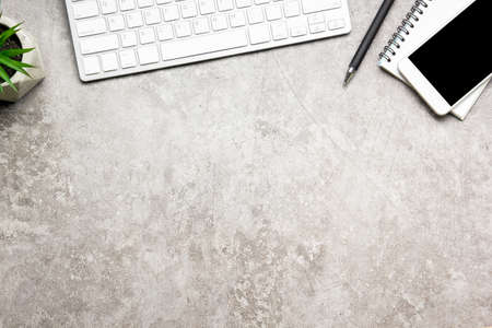 White desk office with laptop, smartphone and other work supplies with cup of coffee. Top view with copy space for input the text. Designer workspace on desk table essential elements on flat lay.の写真素材