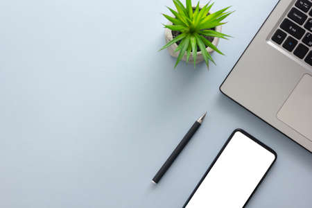 White desk office with laptop, smartphone and other work supplies with cup of coffee. Top view with copy space for input the text. Designer workspace on desk table essential elements on flat lay.の写真素材