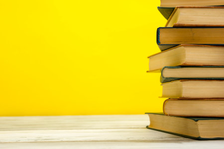 Open book, hardback books on wooden table. Back to school. Copy space.の写真素材
