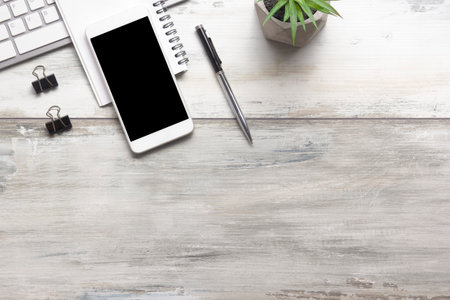 White desk office with laptop, smartphone and other work supplies with cup of coffee. Top view with copy space for input the text. Designer workspace on desk table essential elements on flat lay.の写真素材