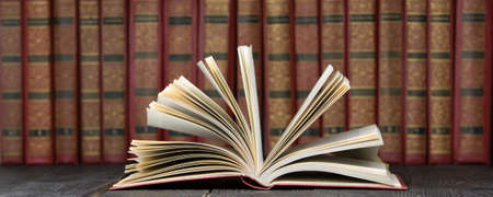 Open book, hardback books on wooden table. Back to school. Copy space.の写真素材