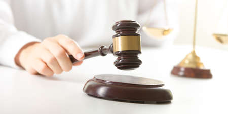 Lawyer working with contract papers and wooden gavel on tabel in courtroom. justice and law, attorney, court judge conceptの写真素材