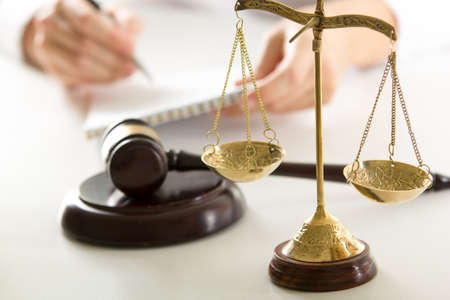 Lawyer working with contract papers and wooden gavel on tabel in courtroom. justice and law, attorney, court judge conceptの写真素材