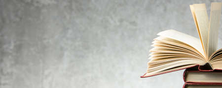 Open book, hardback books on wooden table. Back to school. Copy space.の写真素材