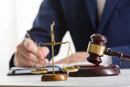 Lawyer working with contract papers and wooden gavel on tabel in courtroom. justice and law, attorney, court judge conceptの写真素材