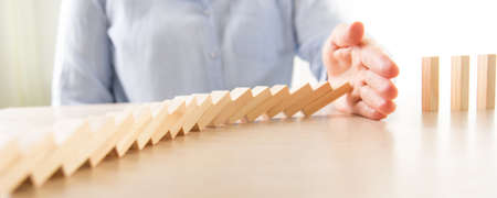 Plan and strategy in business, Risk To Make Business Growth Concept With Wooden Blocks, hand of man has piling up and stacking a wooden blockの写真素材