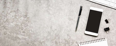 White desk office with laptop, smartphone and other work supplies with cup of coffee. Top view with copy space for input the text. Designer workspace on desk table essential elements on flat lay.の写真素材