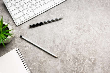 White desk office with laptop, smartphone and other work supplies with cup of coffee. Top view with copy space for input the text. Designer workspace on desk table essential elements on flat lay.の写真素材