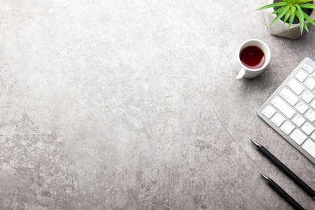 White desk office with laptop, smartphone and other work supplies with cup of coffee. Top view with copy space for input the text. Designer workspace on desk table essential elements on flat lay.の写真素材