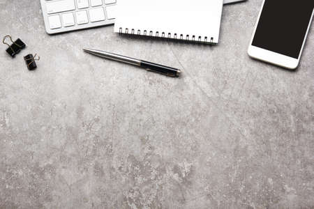 White desk office with laptop, smartphone and other work supplies with cup of coffee. Top view with copy space for input the text. Designer workspace on desk table essential elements on flat lay.の写真素材