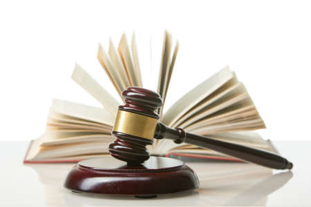Legal Law and Justice concept - Open law book with a wooden judges gavel on table in a courtroom or law enforcement office. Copy space for textの写真素材