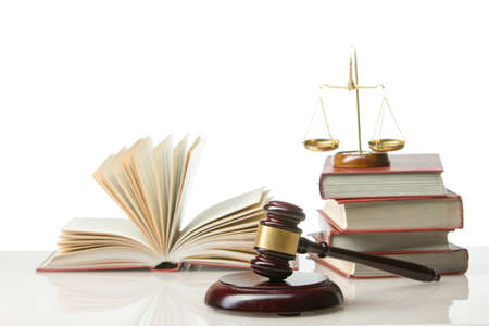 Legal Law and Justice concept - Open law book with a wooden judges gavel on table in a courtroom or law enforcement office. Copy space for textの写真素材