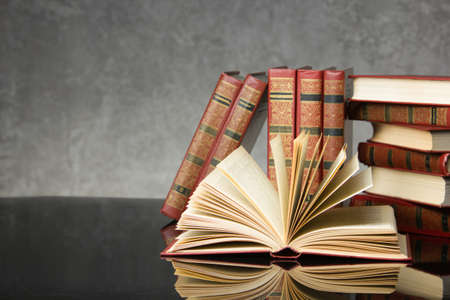 Open book, hardback books on wooden table. Back to school. Copy space.の写真素材