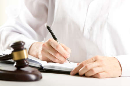 Lawyer working with contract papers and wooden gavel on tabel in courtroom. justice and law, attorney, court judge conceptの写真素材