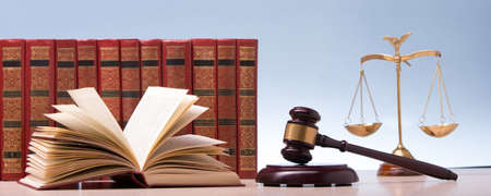 Legal Law and Justice concept - Open law book with a wooden judges gavel on table in a courtroom or law enforcement office. Copy space for textの写真素材