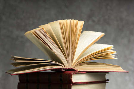 Open book, hardback books on wooden table. Back to school. Copy space.の写真素材