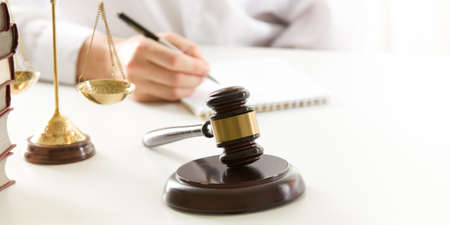 Lawyer working with contract papers and wooden gavel on tabel in courtroom. justice and law ,attorney, court judge concept.の写真素材