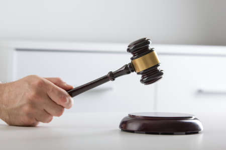 Lawyer working with contract papers and wooden gavel on tabel in courtroom. justice and law ,attorney, court judge concept.の写真素材