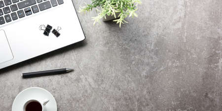 White desk office with laptop, smartphone and other work supplies with cup of coffee. Top view with copy space for input the text. Designer workspace on desk table essential elements on flat layの写真素材