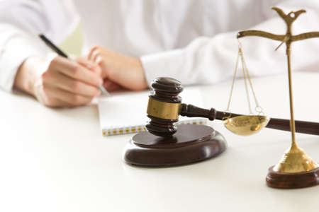 Lawyer working with contract papers and wooden gavel on tabel in courtroom. justice and law, attorney, court judge conceptの写真素材
