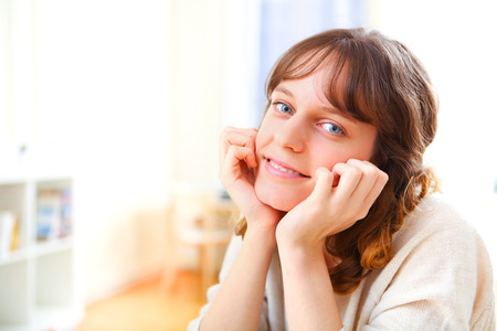 View of a young attractive woman relaxing on sofaの写真素材
