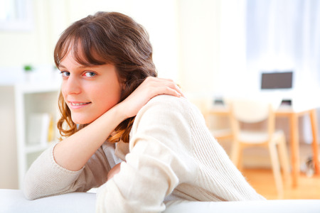 View of a young attractive woman relaxing on sofaの写真素材