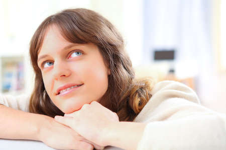 View of a young attractive woman relaxing on sofaの写真素材