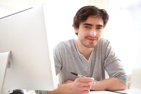 View of a young relaxed men writting at the office の写真素材