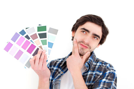 View of a Attractive young man choosing color of his flatの写真素材