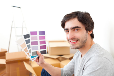 View of an Attractive young man choosing color of his flatの写真素材