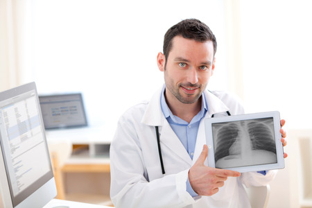 View of a Young doctor showing radiography on a tablet