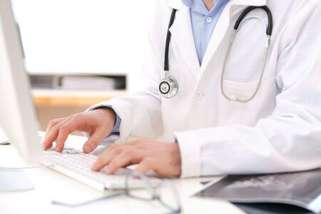 View of Details of doctor hands typing on keyboardの写真素材