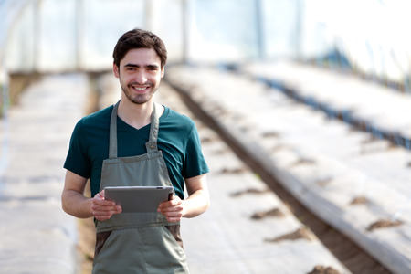 View of a Young business farmer working on his tablet