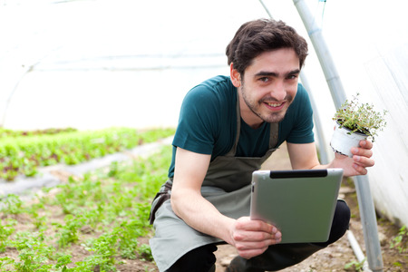 View of a Young business farmer working on his tabletの写真素材