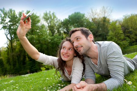 View of a Young couple taking selfie picture at the parkの写真素材