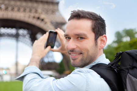 View of a Young attractive tourist taking picture in Parisの写真素材