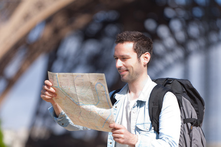 Young attractive tourist reading map in Paris, Franceの写真素材